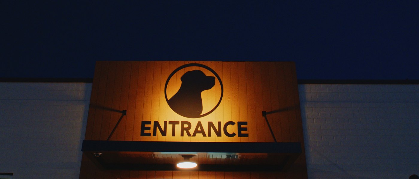 The lit entrance canopy at Columbia Pike Animal Hospital and Emergency Center at night