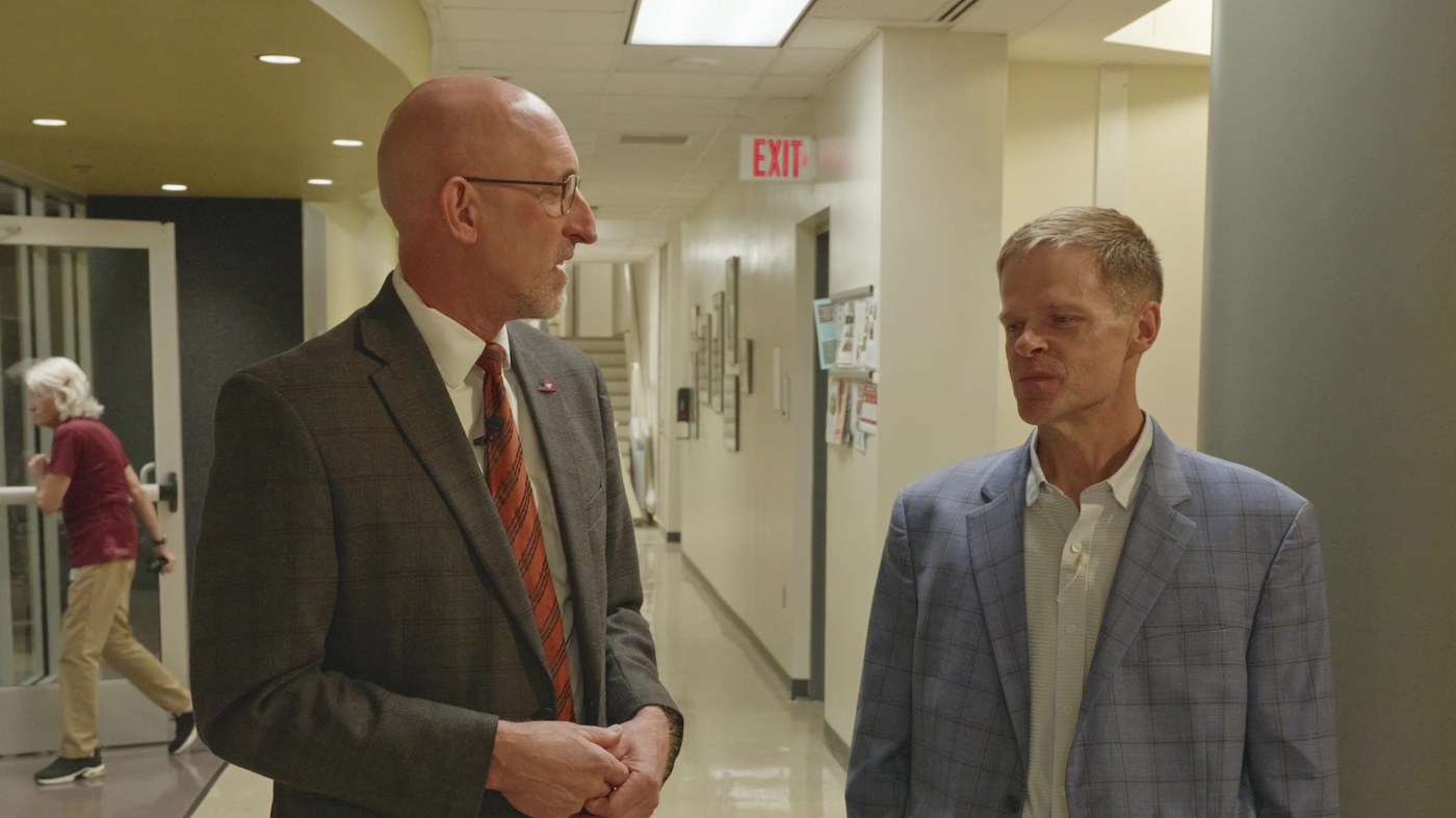 Dean Dan Givens and Dr. Reed Hall talking in a hallway of the Veterinary Teaching Hospital in Blacksburg