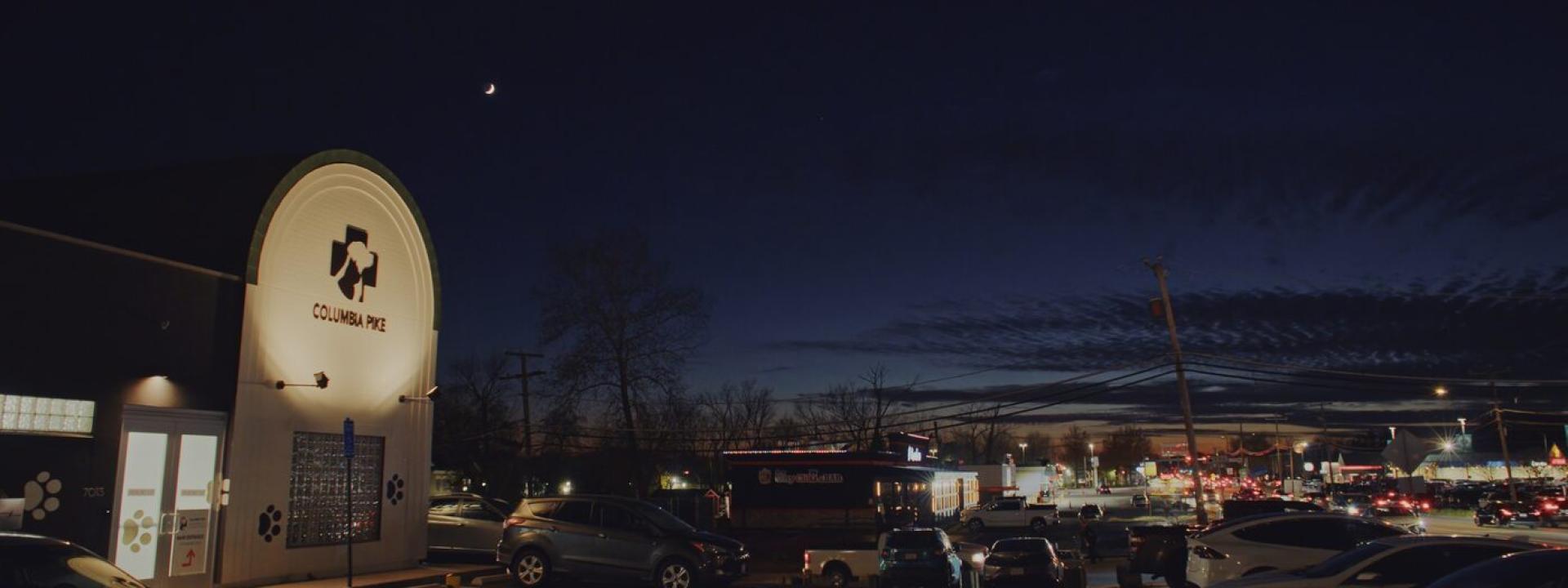 Columbia Pike Animal Hospital exterior at night, sign lit up with moon visible